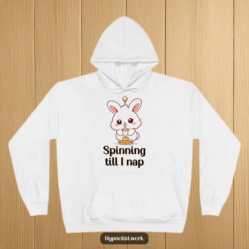 Funny hoodie featuring a fluffy bunny with swirly eyes spinning hypnotically with a small pendulum, offering cozy, humorous vibes.